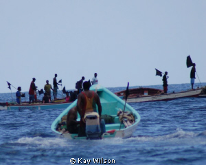 Fishing community funeral procession. by Kay Wilson 